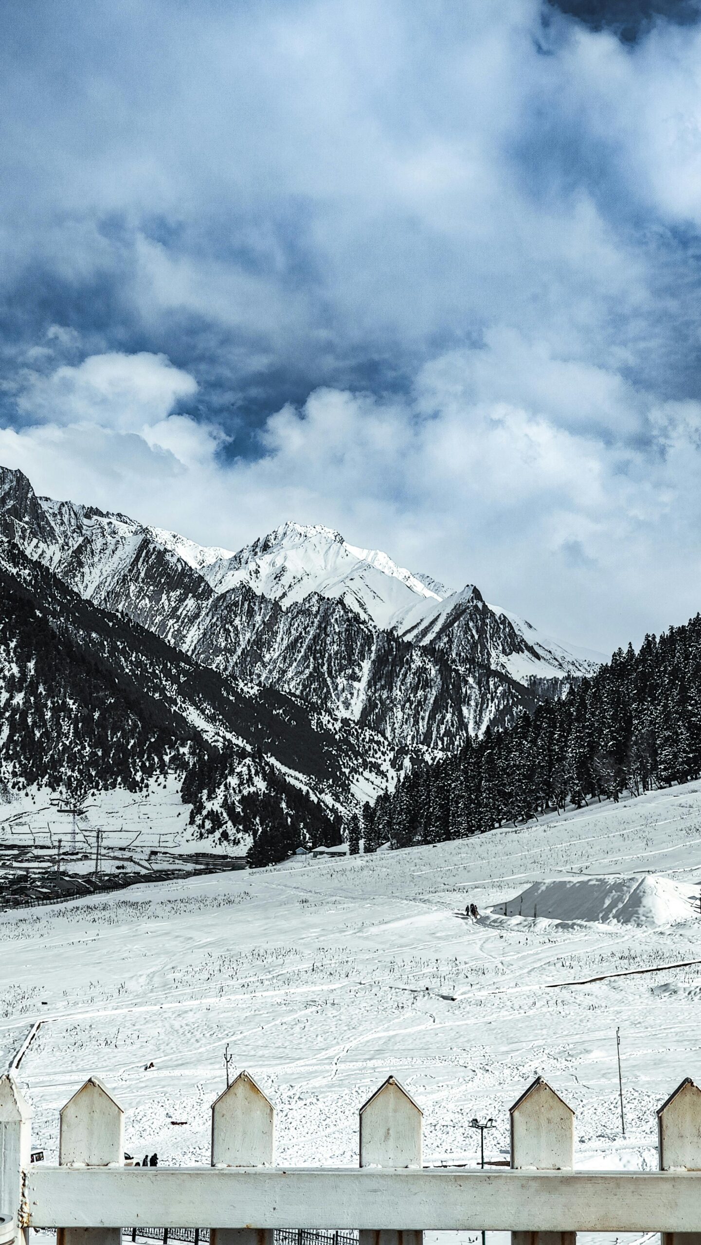 Breathtaking view of snowy mountains and cloudy sky in Sonamarg, perfect for winter themes.
