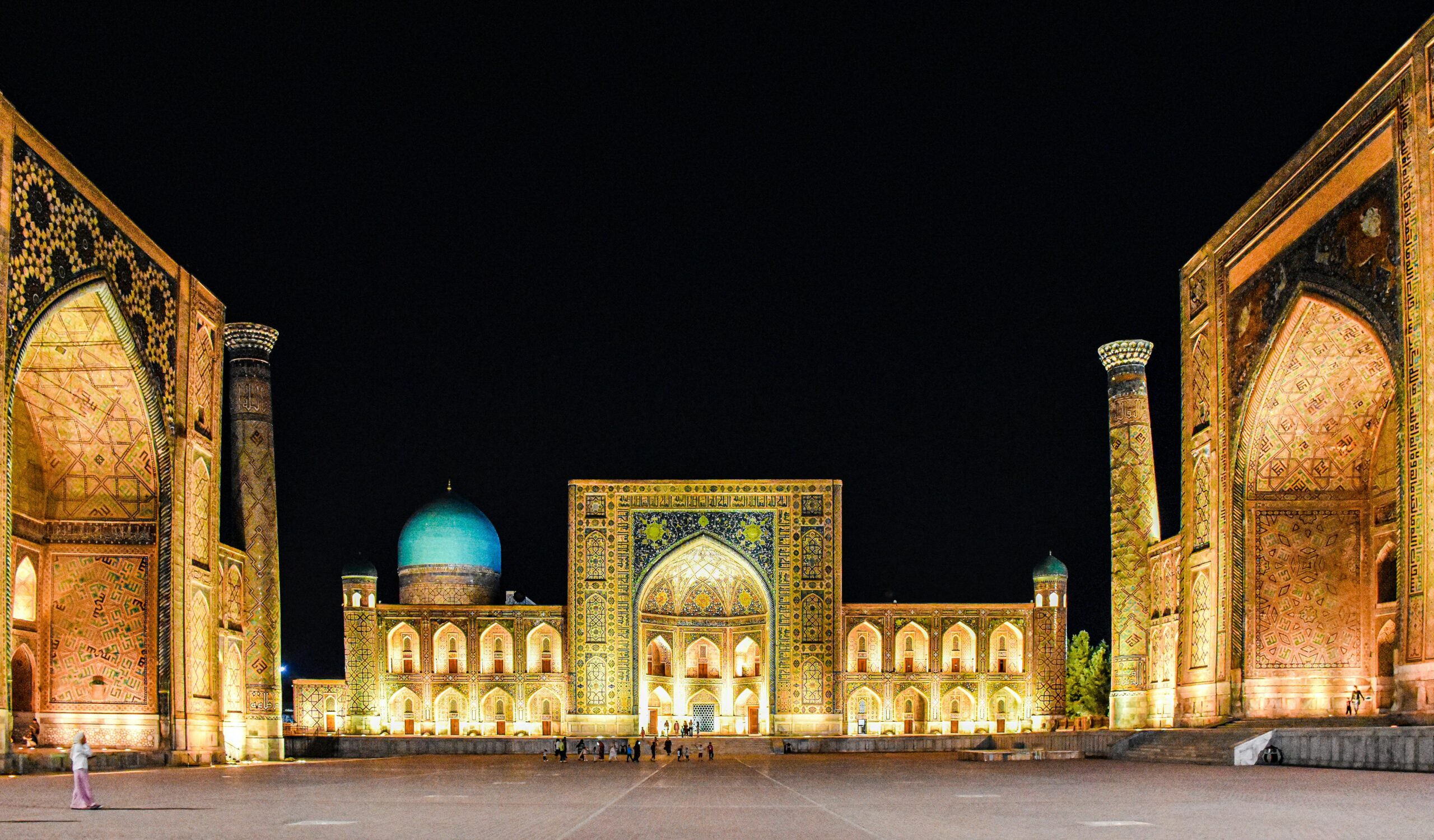 Illuminated Registan Square, Samarkand, Uzbekistan, showcasing Islamic architecture at night.