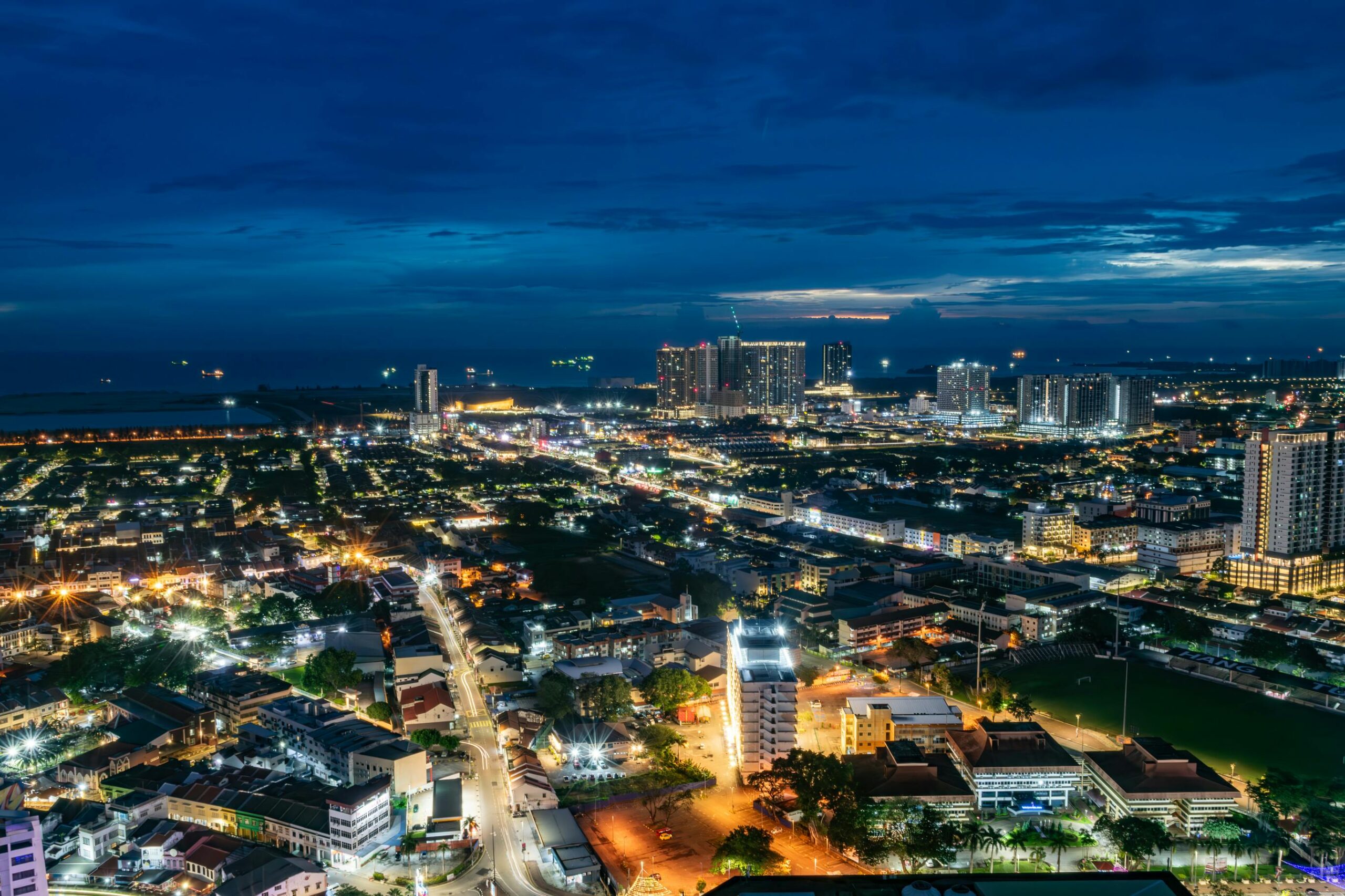 A breathtaking aerial night view of Malacca's illuminated cityscape in Malaysia.
