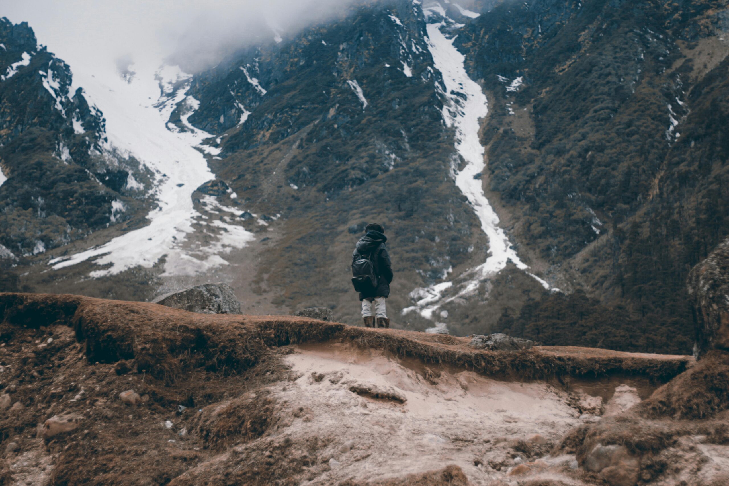 Solo adventurer stands on a rugged ridge in the Himalayan mountains, Gangtok.