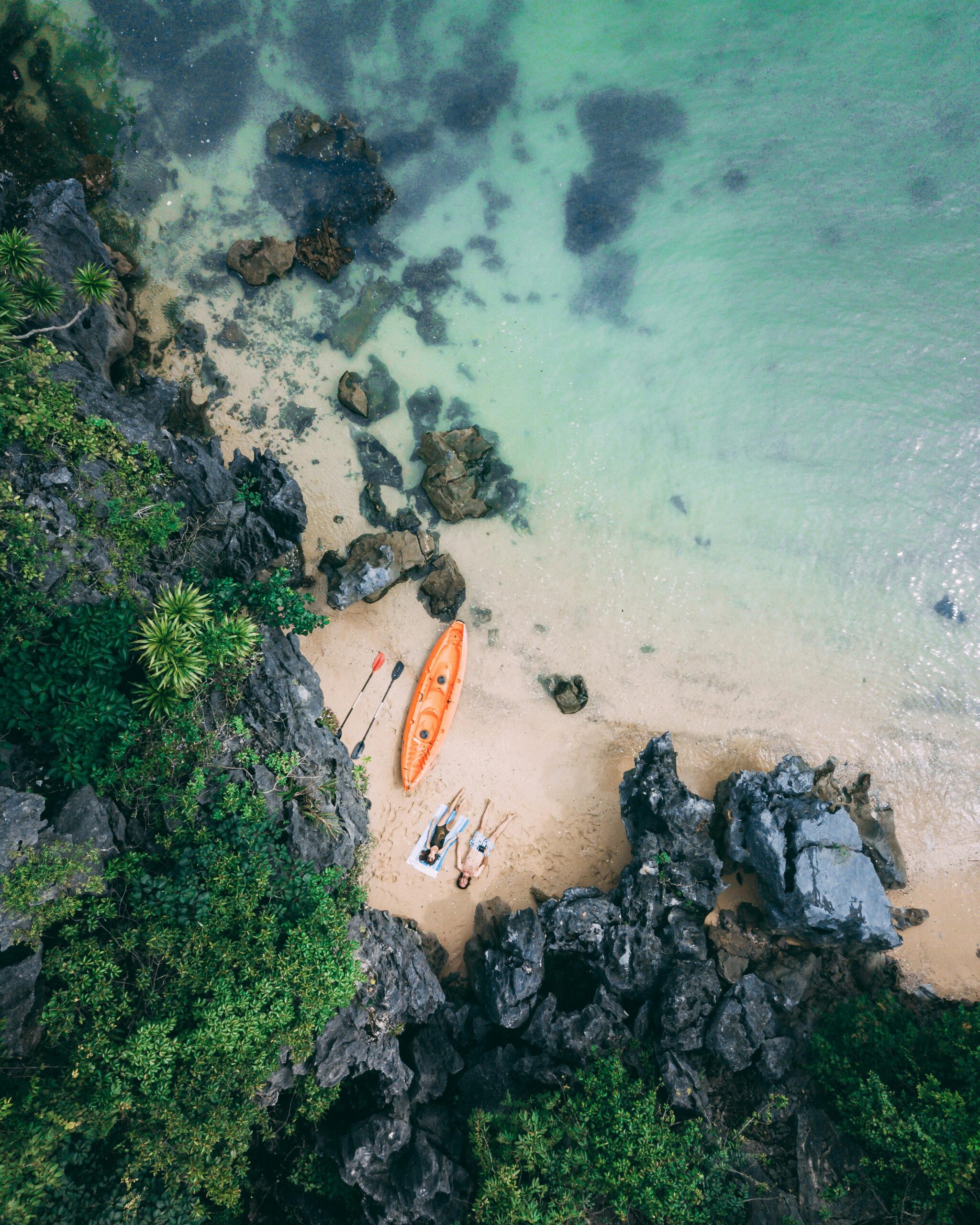 Captivating aerial shot of a serene beach with a kayak in Vietnam.
